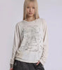 Fallen Scholar Distressed Text Graphic Long Sleeve Top in Washed Cream