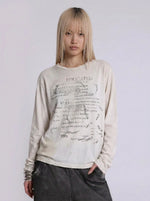 Fallen Scholar Distressed Text Graphic Long Sleeve Top in Washed Cream